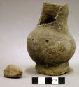 Ceramic complete vessel, plain, short broken neck, six sherds inside