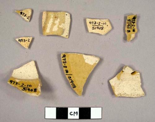 Glazed potsherds. cream pottery with yellow glaze.