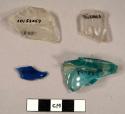 Clear glass fragments, one with pressed pattern.