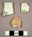 2 rim sherds, 1 body sherd. white, with painted floral motifs.