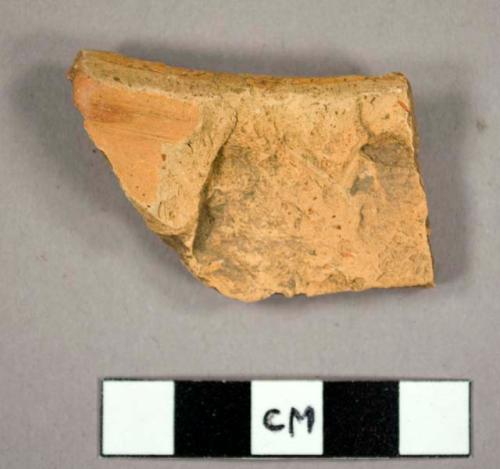 Rim sherd, trace of ochre glaze one side.