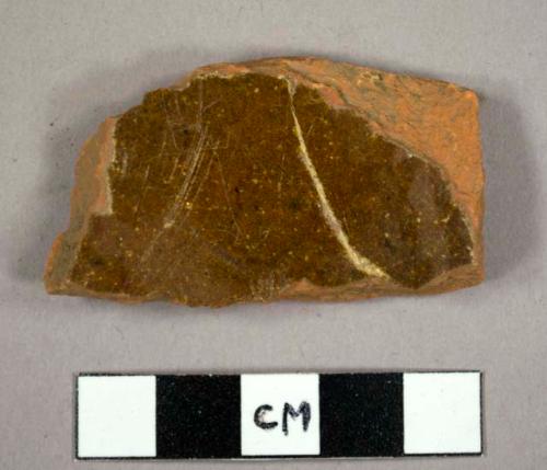 Body sherd, ochre glaze 1 side.