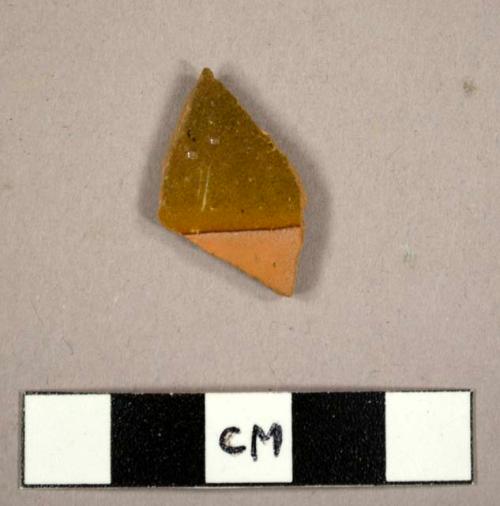 Body sherd, ochre glaze 1 side.