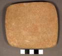 Abrading stone. rectangular slab. periphery shaped & flattened. 1 slightly conve