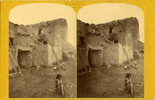 Hopi child sitting near entrance to Walpi