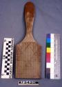 Pottery paddle with check stamp design. Also has linear stamp design