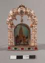 Image of pagoda in standing molded metal frame with clear glass ornaments and painted ovals along the bottom front; packaged in a cardboard box with circular cutout, labeled 'Kulin Jewellers'