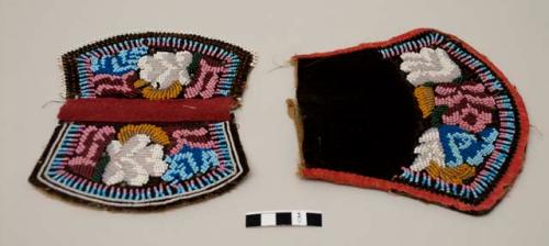 Pouch with stylized floral beadwork design in white, clear, light pink, dark pink, light blue, dark blue, orange, gold, dark green and black beads on dark velvet; red silk edging worn/rotted; red wool at top of flap