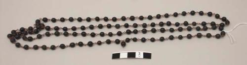 Buddhist rosary; copper links, spherical dark brown seeds?