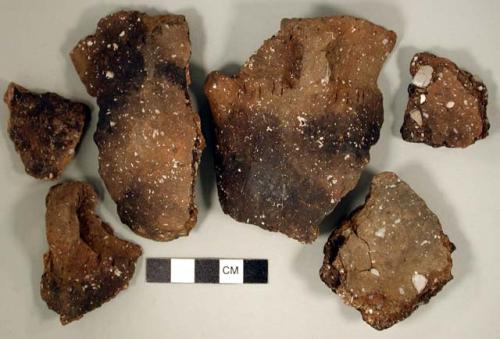 Ceramic, earthenware body, rim, and handle sherds; chipped stone, flake; organic, bone fragments