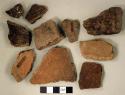 Coarse earthenware body sherds, some undecorated, some cord impressed, some incised; mica fragment