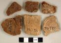 Coarse earthenware body sherds, cord impressed, some with iron residue; unidentified iron fragment