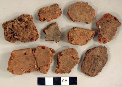 Coarse earthenware body and rim sherds, some undecorated, one incised, one rocker dentate