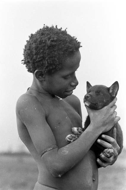 Kusa holding puppy