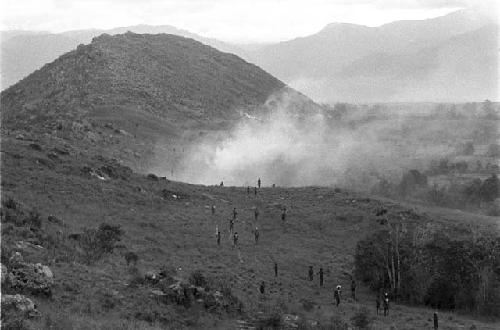 Men coming back along the Warabara; fire in distance