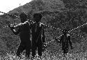 Werené and other men walking in the fields