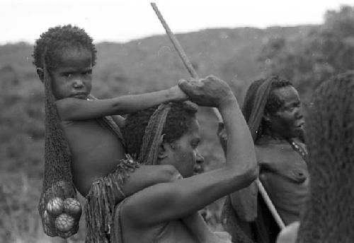 Woman carrying child on her shoulders