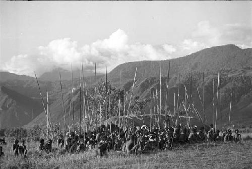 Group of men in front of the oléa; NE mt. wall behind at Liberek during an Etai