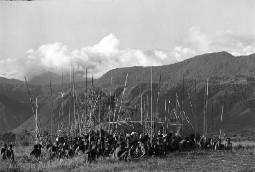 Group of men in front of the oléa; NE mt. wall behind at Liberek during an Etai