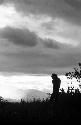 Man silhouetted against a late evening sky