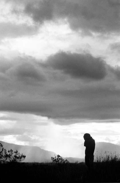 Man silhouetted against a late evening sky