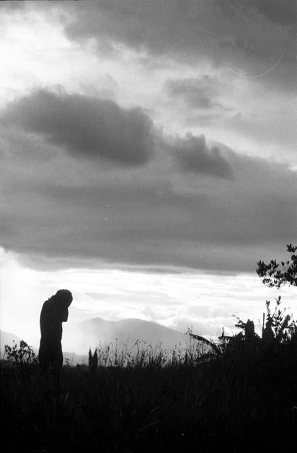 Man silhouetted against a late evening sky