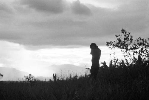 Man silhouetted against a late evening sky