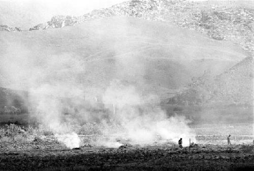 Distant view over the valley; burning of trash in the frgd; kaio in the distance and the Supula in the bkgd