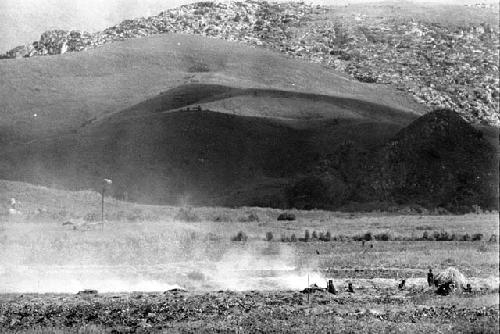 Distant view over the valley; burning of trash in the frgd; kaio in the distance and the Supula in the bkgd