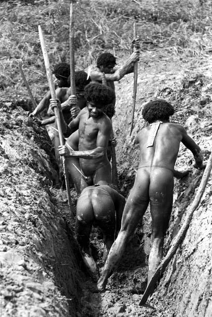 men working in a ditch