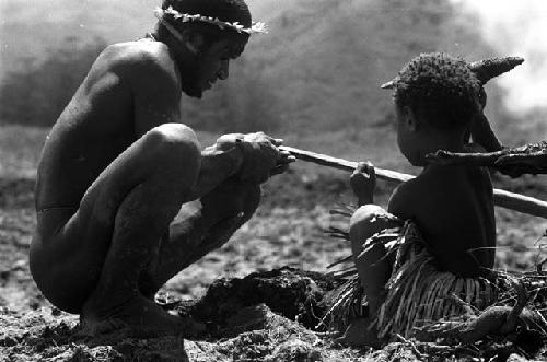 child holds stone axe