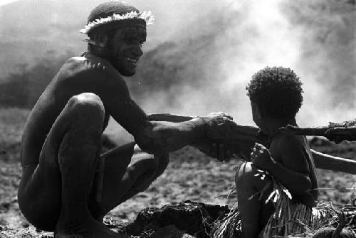 child holds stone axe