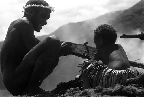 child holds stone axe