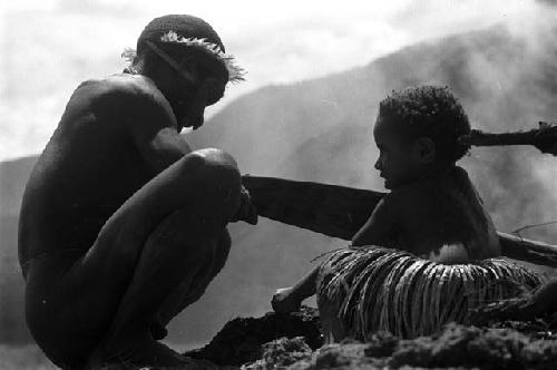 child holds stone axe