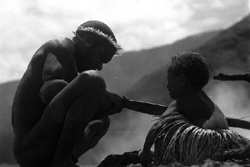 child holds stone axe