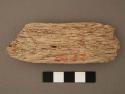 Piece of ironwood, roughly rectangular shape. l: 10 cm.