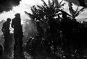 Silhouette shot of men mourning at the funeral for a woman at Abulupak