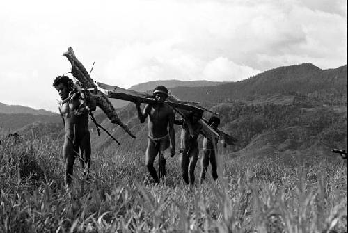 Men carrying wood to Abulupak to burn the woman; Woluklek in the lead