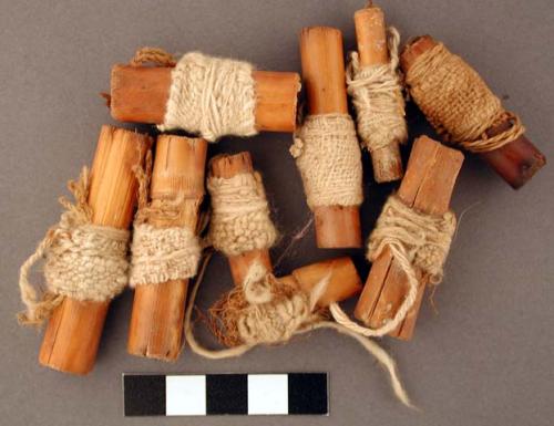 Wood, Cane cigarettes wrapped in cotton fabric and knotted twine.