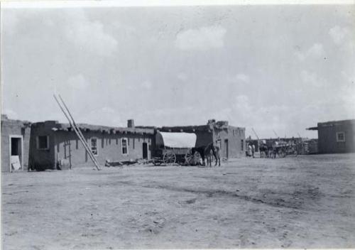 Horse and wagon outside village pueblos