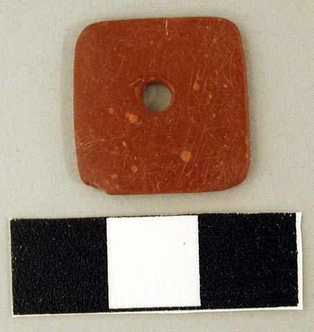 Square red stone pendant, perforated in center