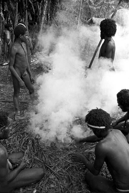 Steam and men working at building the hakse