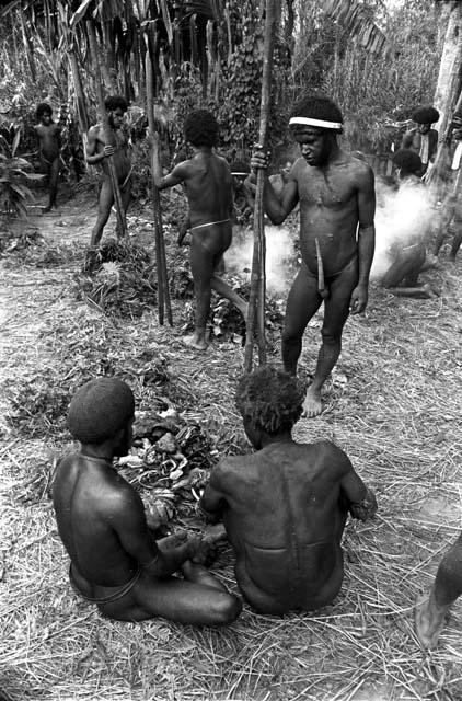 From behind Yege Asuk who sits thinking he's wounded