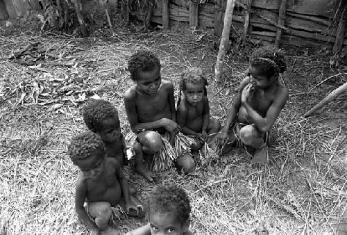 4 or 5 young girls wait near the entrance to the back sili of Abulupak