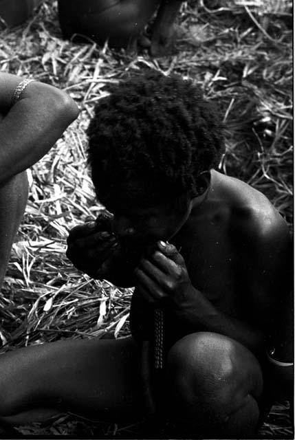 Another boy eating a mouse