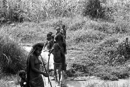 Women walk near Abulupak on their way to the fields to work