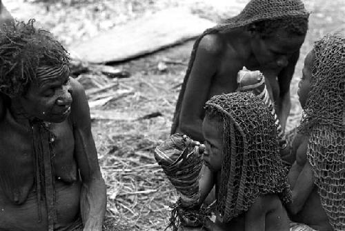 The little girls who had their fingers chopped off sitting outside of the hunu in Haliolé's sili they talk to an old woman