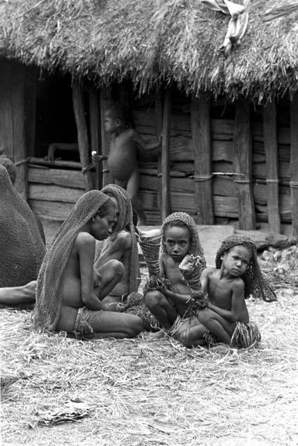 The two girls and old woman watch what is going on