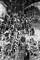 Men mourning behind the chair; Molaré stands near the chair