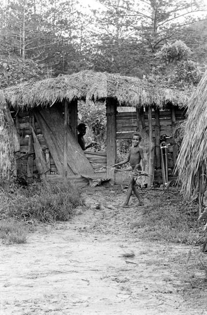 Boy coming into the sili thru the entryway of Abulupak